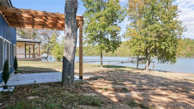 view of yard with a water view and a pergola