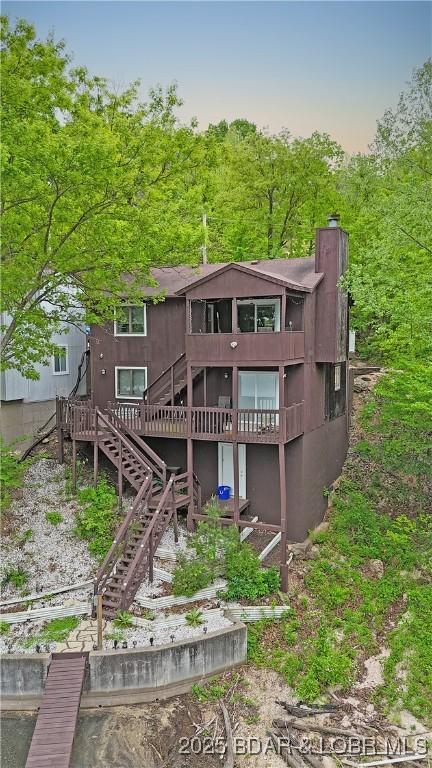 26553 Mesa Dr, Rocky Mount, MO 65072 - back of property featuring stairway, a chimney, and a wooden deck