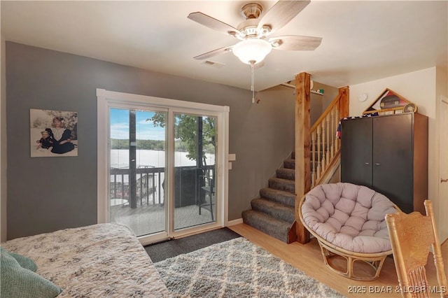 26553 Mesa Dr, Rocky Mount, MO 65072 - entryway with wood finished floors, a ceiling fan, stairs, and a water view