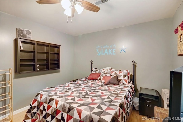 26553 Mesa Dr, Rocky Mount, MO 65072 - bedroom with wood finished floors and ceiling fan