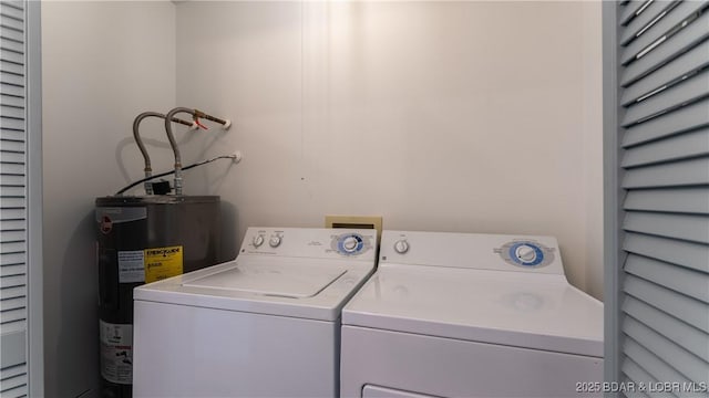 washroom with water heater and washer and dryer