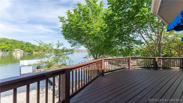 wooden terrace featuring a water view
