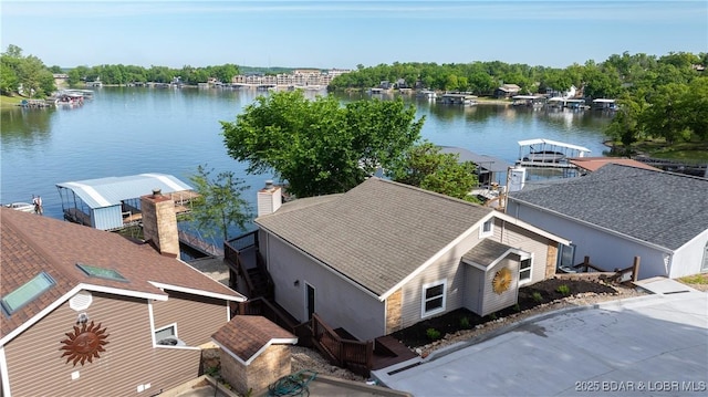 aerial view of property and surrounding area featuring a nearby body of water