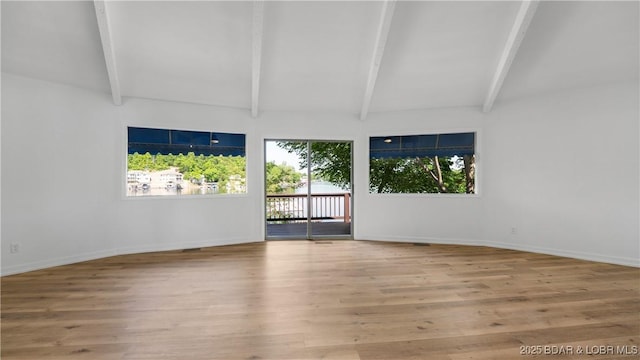 empty room featuring wood finished floors and baseboards