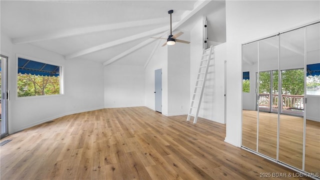 unfurnished living room with beamed ceiling, wood finished floors, a ceiling fan, high vaulted ceiling, and baseboards