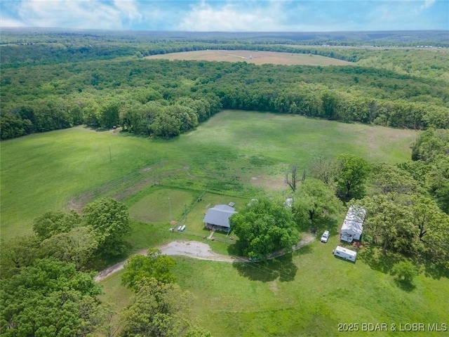 aerial overview of property's location with rural landscape and a forest