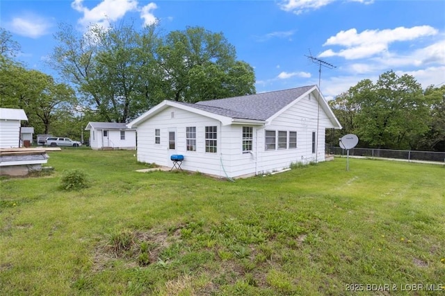 back of property with roof with shingles