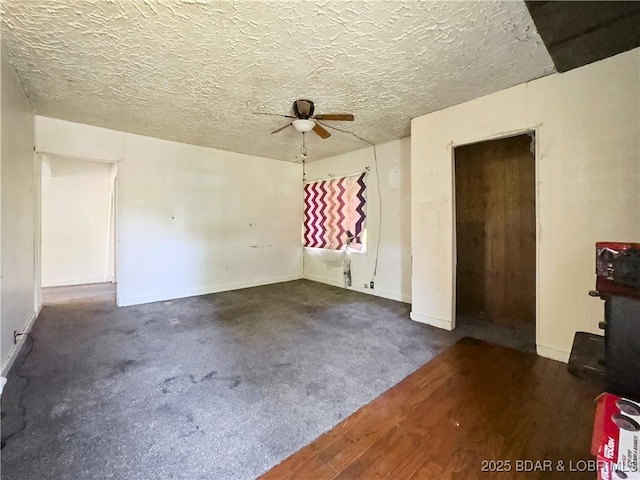 spare room with ceiling fan, baseboards, and wood finished floors