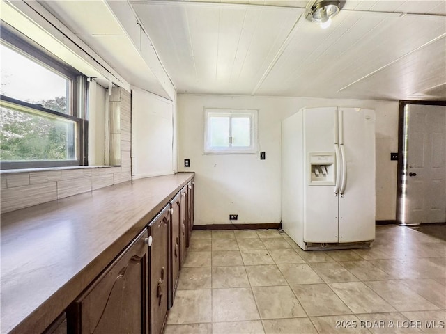 washroom featuring light tile patterned floors and baseboards