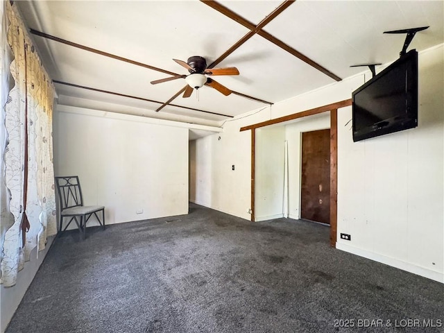 unfurnished living room featuring carpet flooring and a ceiling fan