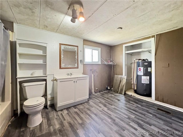 below grade area featuring water heater and wood finished floors