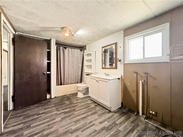 full bathroom with wood finished floors, vanity, toilet, and shower / bath combo