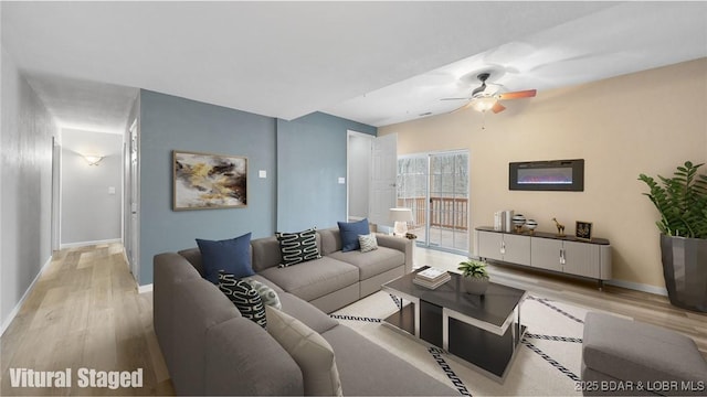 living room featuring wood finished floors, ceiling fan, and baseboards