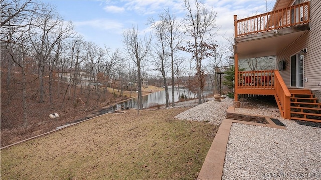 view of yard with a deck with water view
