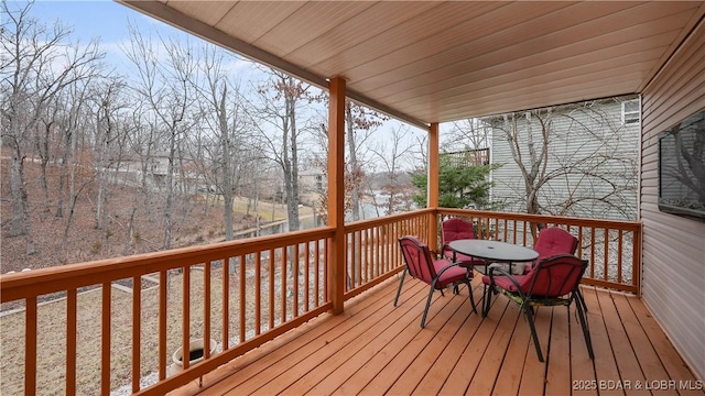 wooden terrace with outdoor dining area