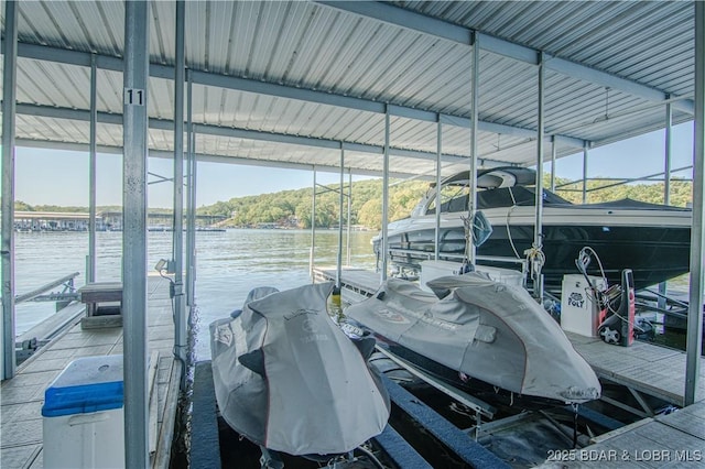 dock area featuring boat lift and a water view
