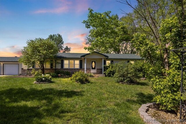 ranch-style home with a front yard and an attached garage