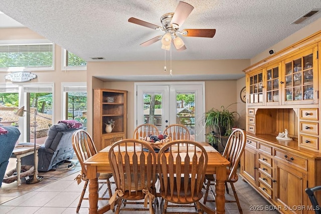 33367 Emerald Rd, Sunrise Beach, MO 65079 - dining space with a textured ceiling, light tile patterned flooring, and ceiling fan