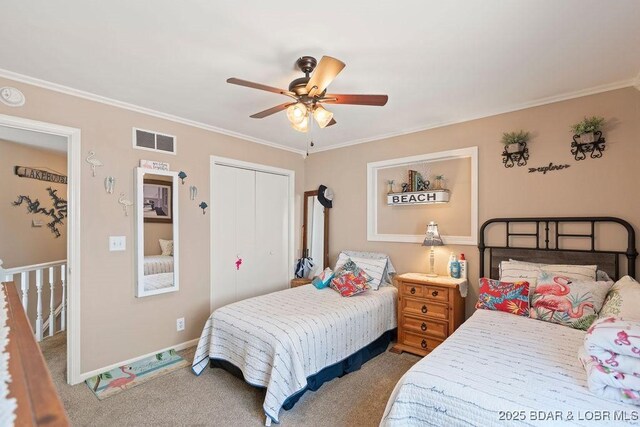 33367 Emerald Rd, Sunrise Beach, MO 65079 - bedroom with ornamental molding, a closet, carpet floors, and a ceiling fan