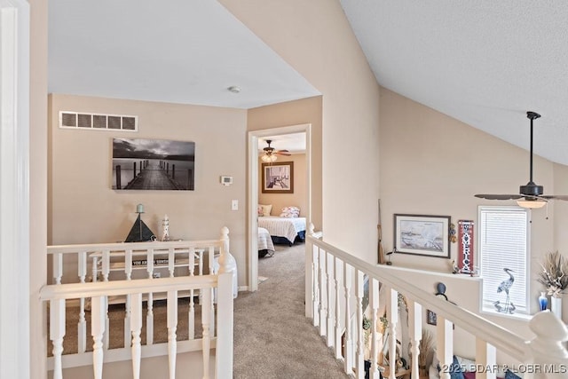 33367 Emerald Rd, Sunrise Beach, MO 65079 - corridor with light colored carpet, vaulted ceiling, and an upstairs landing