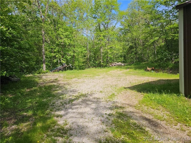 view of yard featuring a forest view