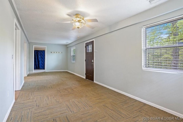 entrance foyer featuring baseboards and ceiling fan