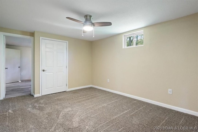 unfurnished bedroom featuring carpet, baseboards, and a ceiling fan