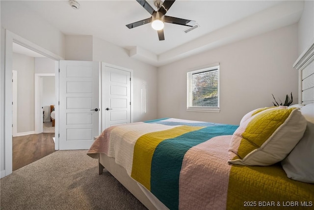 carpeted bedroom featuring a ceiling fan and baseboards