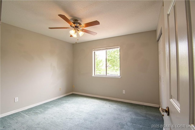 empty room featuring carpet flooring, baseboards, a ceiling fan, and a textured ceiling