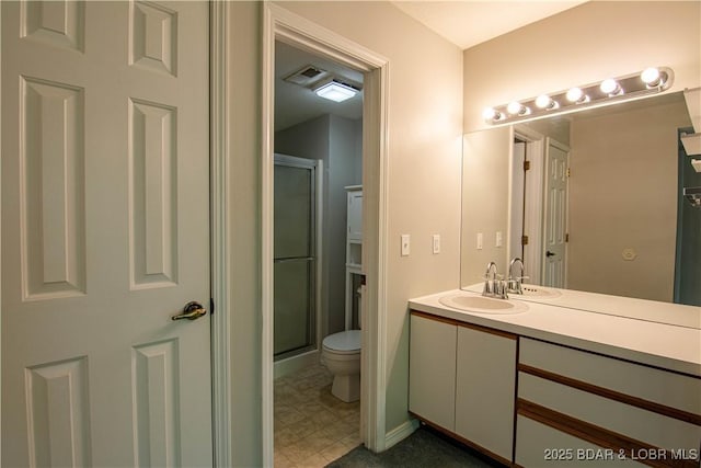 bathroom with toilet, a stall shower, and vanity