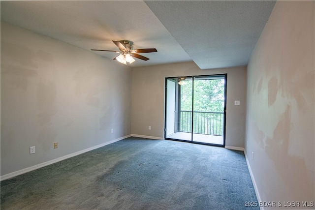 carpeted empty room with a ceiling fan and baseboards