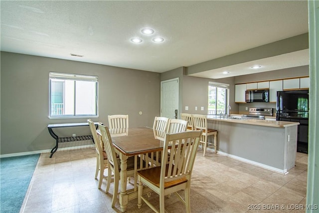 dining room featuring recessed lighting and baseboards