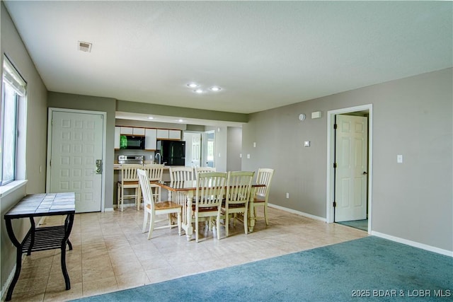 dining space with healthy amount of natural light, baseboards, recessed lighting, and light tile patterned floors