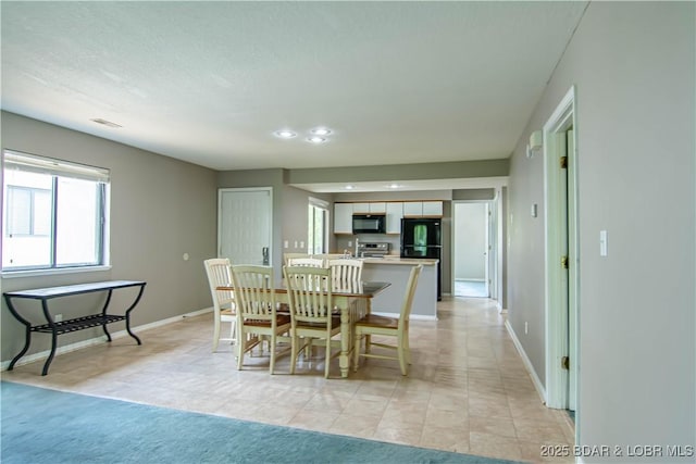 dining room featuring baseboards, recessed lighting, and light tile patterned floors