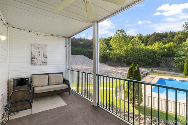 balcony with ceiling fan and view of pool area