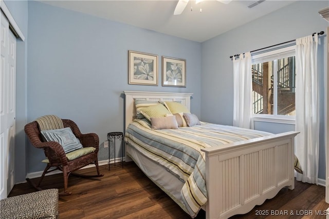bedroom with dark wood finished floors, a closet, baseboards, and a ceiling fan