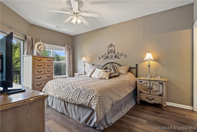 bedroom with dark wood-style floors, baseboards, and ceiling fan