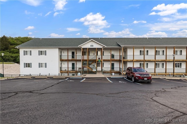 view of building exterior with uncovered parking