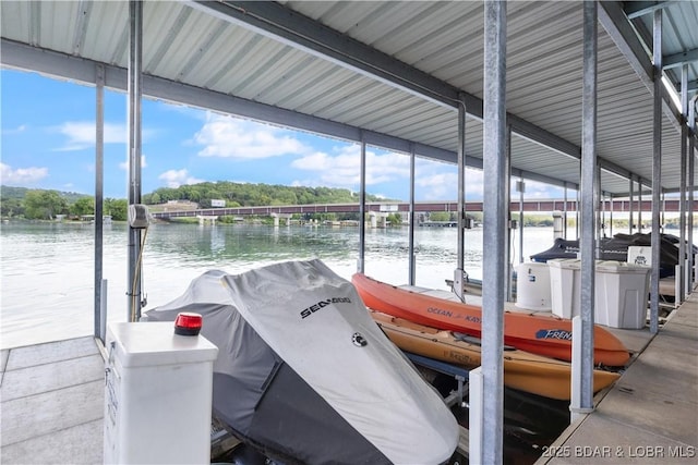 dock area featuring boat lift and a water view