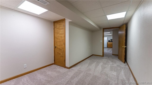 907 Sunnyview Cir, Eldon, MO 65026 - empty room with light carpet, a drop ceiling, and baseboards