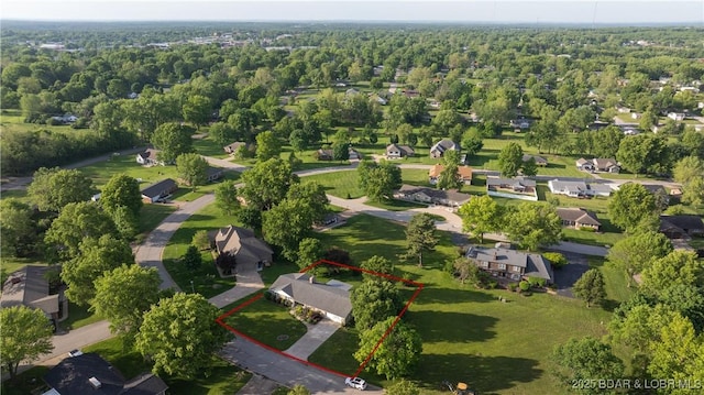 907 Sunnyview Cir, Eldon, MO 65026 - aerial perspective of suburban area with property parcel outlined and a heavily wooded area