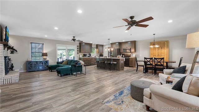 907 Sunnyview Cir, Eldon, MO 65026 - living area featuring ceiling fan, light wood finished floors, recessed lighting, and a fireplace