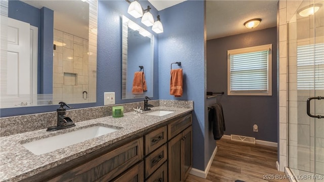 907 Sunnyview Cir, Eldon, MO 65026 - full bath featuring a stall shower, wood finished floors, baseboards, and double vanity