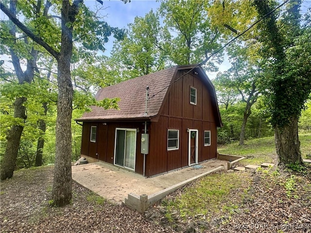 30020 Cool Valley Dr, Rocky Mount, MO 65072 - back of property featuring a gambrel roof, roof with shingles, and an outdoor structure