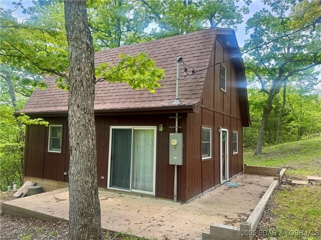 30020 Cool Valley Dr, Rocky Mount, MO 65072 - back of house featuring roof with shingles