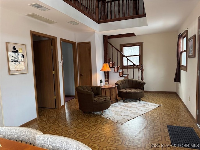 30020 Cool Valley Dr, Rocky Mount, MO 65072 - living area with tile patterned floors, stairs, and baseboards