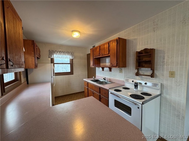 30020 Cool Valley Dr, Rocky Mount, MO 65072 - kitchen with white electric range, a sink, brown cabinets, and backsplash