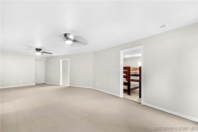 empty room with a ceiling fan and baseboards