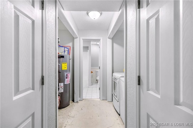 laundry room featuring washer and clothes dryer and water heater