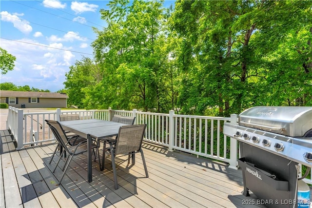 wooden deck featuring a grill and outdoor dining space